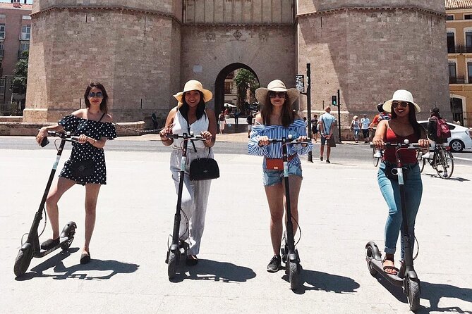 E-Scooter Grand Valencia Private Tour - Torres de Serranos: riding up to a medieval gate